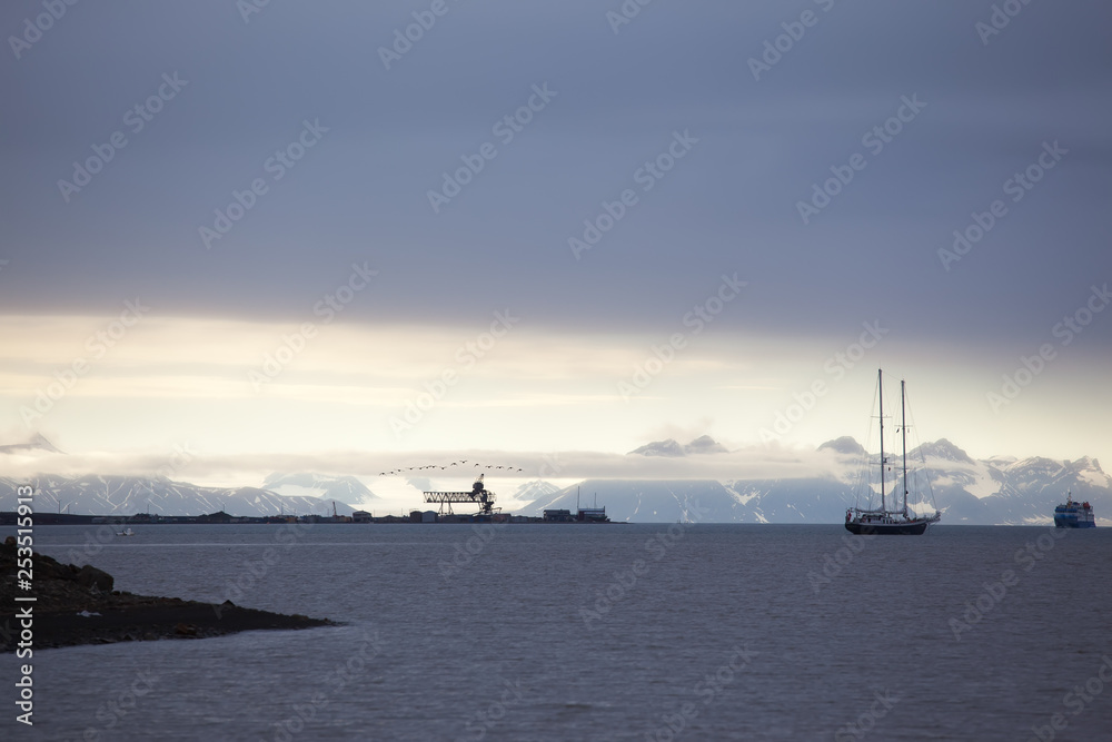 ships in the bay fjord of Longyearbyen Svablbard of Norway at sunset