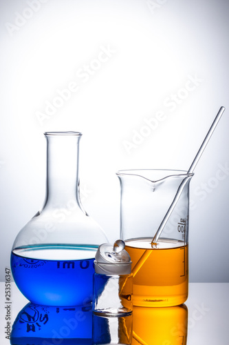 laboratory flask with blue and orange liquid