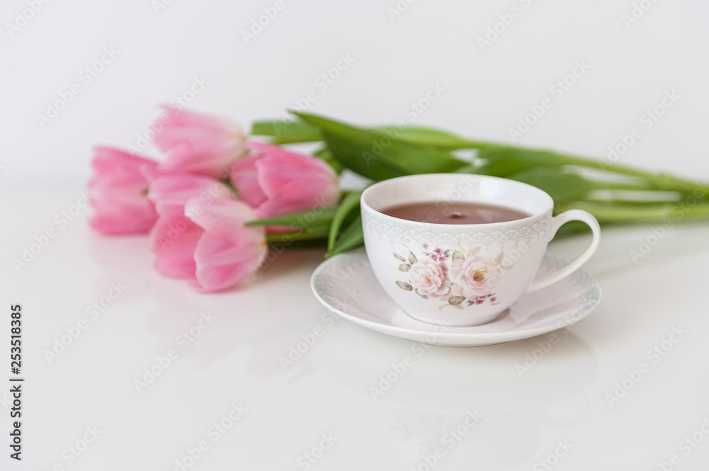 Morning tea with pink tulips on white table. Close up. Soft focus. Spring concept. Happy Mother's Day, Women's Day or Birthday. Minimalism, copy space. Morning tea with pink tulips on white table. Close up. Soft focus. Spring concept. Happy Mother's Day, Women's Day or Birthday. Minimalism, copy space.
