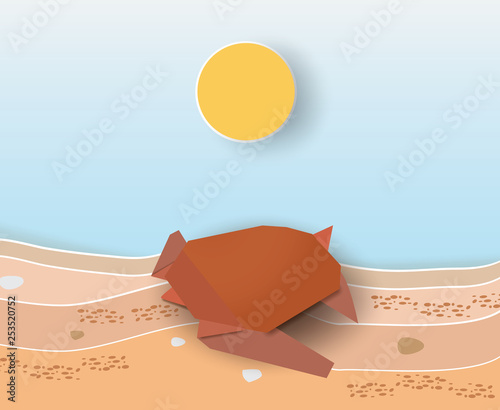 Origami turtle on the sands with sunrise.
