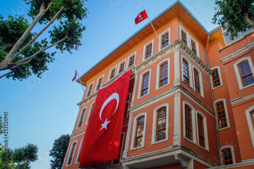 Photography Beautiful baroque building with a huge Turkish flag on the facade