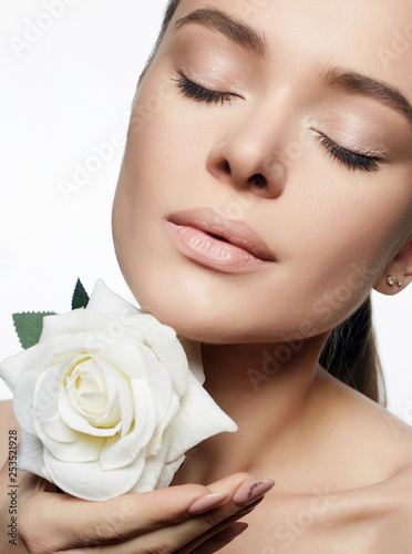 Beautiful Young Woman with Flower. Beauty Portrait