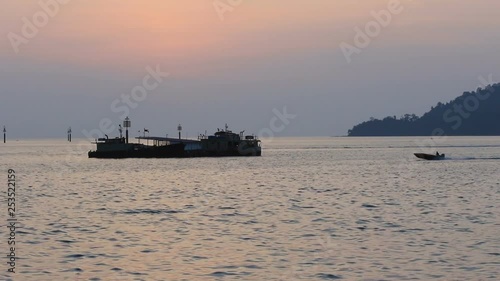 Footage of Fisherman boat Pass-by at Waterfront Kota Kinabalu, Sabah, Borneo during Beautiful sunseet .Kota Kinabalu waterfront is famous tourist spot during sunset. photo