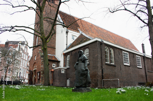 secret garden of the beghine of amsterdam. statue in the middle of the green in the reserved and silent neighborhood inhabited by religious people