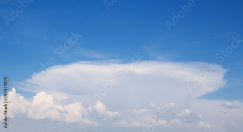 White fluffy clouds against a blue sky,