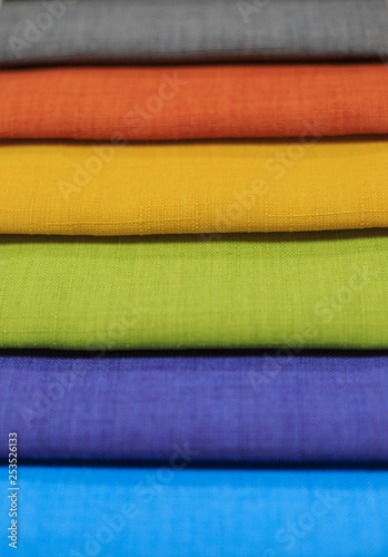 Textile samples. Textile samples for curtains. Yellow, blue, orange, green tone curtain samples hanging.