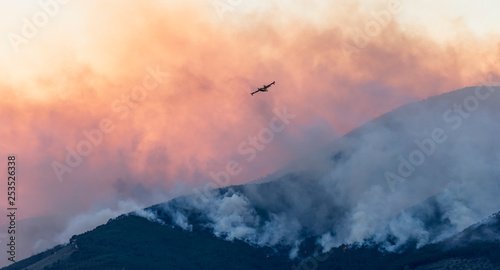Canadair busy turning off a huge fire in the beautiful sunset light