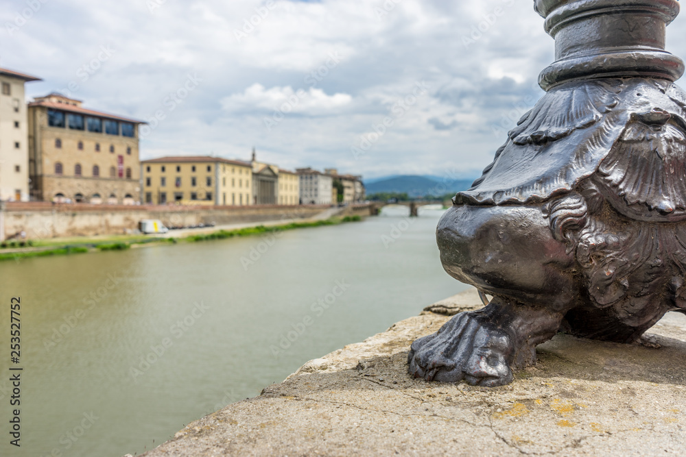 The base of the lamp post near Ponte Vecchio over the Arno River in Florence, Italy