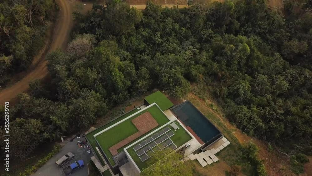 Modern home with solar panels in a tropical forest. Modern home with solar panels in a tropical forest.