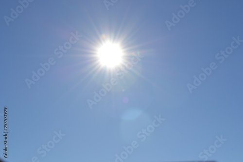 Sun with rays on a blue sky