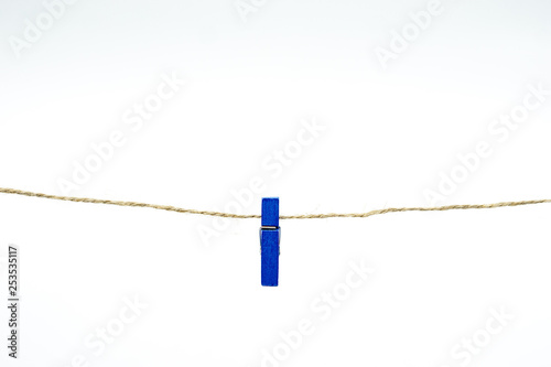Cloth peg isolated on white background. Blue color.