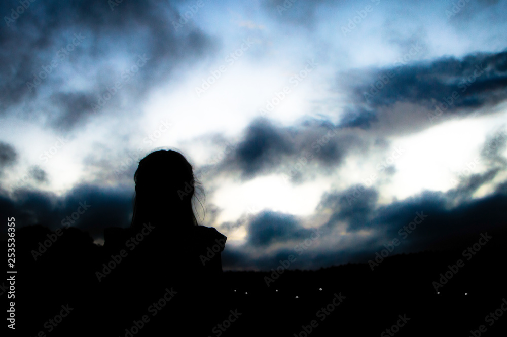 silhouette of girl at night