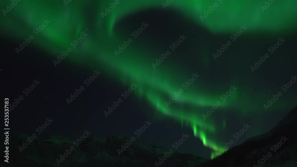 The northern lights filmed in real time over mountain landscape on the island Kvaløya near Tromsø in nothern norway The northern lights filmed in real time over mountain landscape on the island Kvaløya near Tromsø in nothern norway