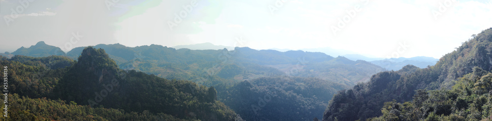 wide panorama of hills and mountains on a nice cloudy evening from a hill top in Northern Thailand, Southeast Asia