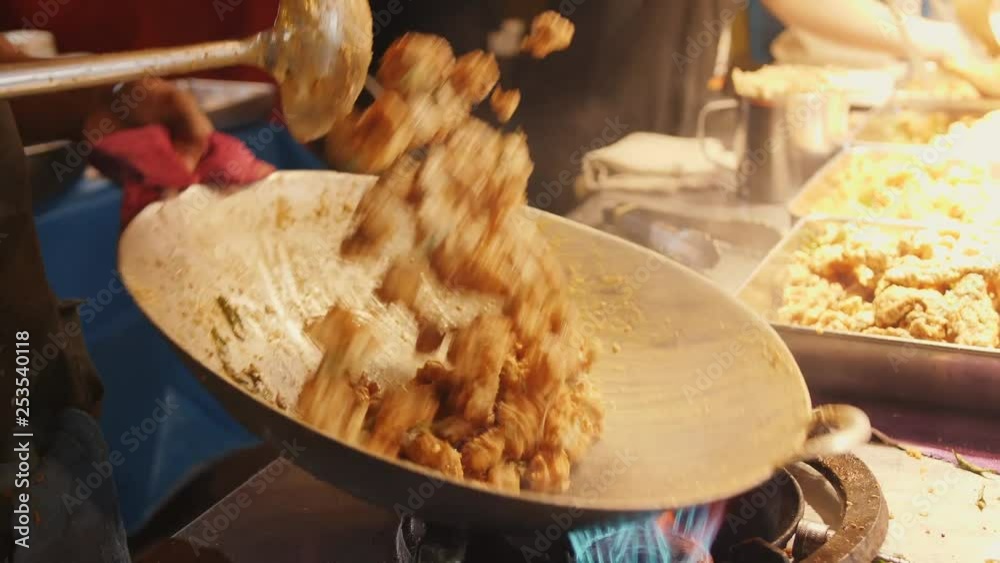 Asian Street food: Chef Cooking Pad Thai in Wok at Night Food Market. 4K Slowmotion. Kuala Lumpur, Malaysia.