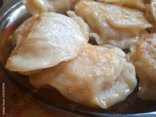Fried Russian dumplings. A delicious dish on a plate. Ruddy dumplings. Delicious ready and traditional Polish dinner.