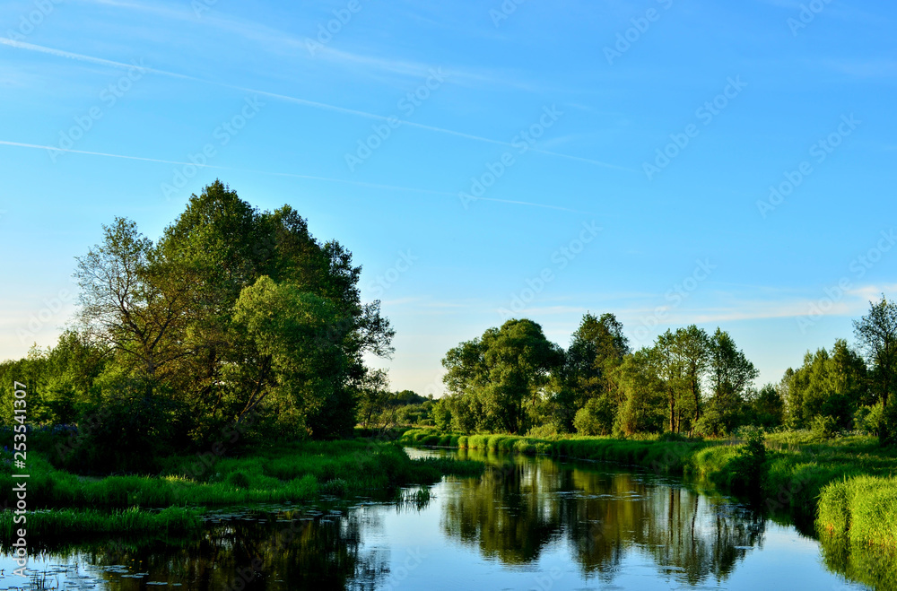 The panoramic background of the natural morning sun landscape represents a beautiful ecological system and a view when traveling in the wild. Republic of Belarus, River The panoramic background of the natural morning sun landscape represents a beautiful ecological system and a view when traveling in the wild. Republic of Belarus, River