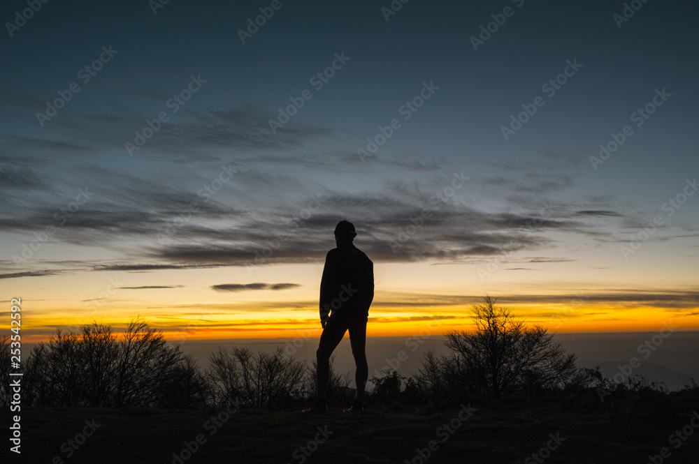 Silhouette of male trail runner at sunrise Silhouette of male trail runner at sunrise