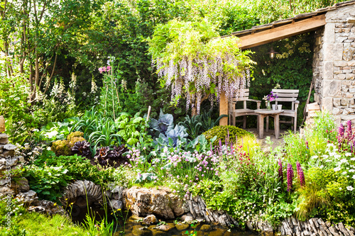 Fototapeta Naklejka Na Ścianę i Meble -  Decorative garden with a patio area in a countryside