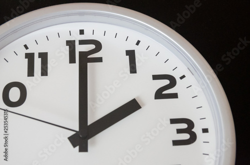 Close up of black and white analog clock with selective focus at 2 Oclock. Time concept