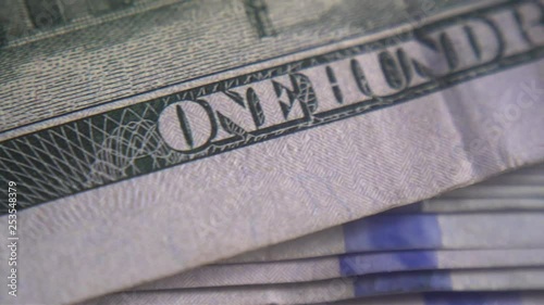A hundred-dollar bill  close up. Financial independence and stock exchange. Cash in the hands of criminal structures.