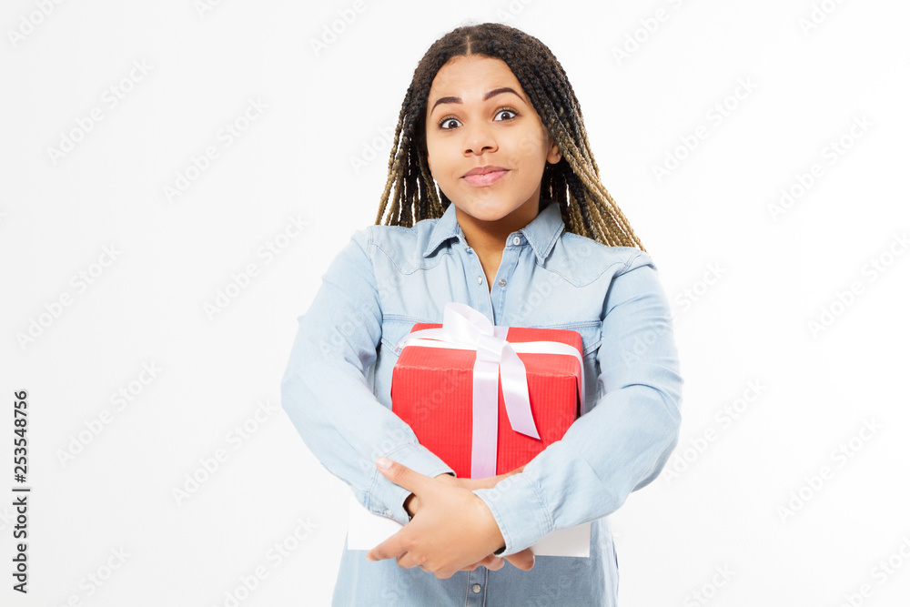 Young beautiful girl in denim shirt hug a big gift box isolated on a white background . Young beautiful girl in denim shirt hug a big gift box isolated on a white background .