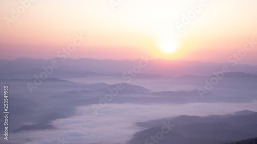 Layer of Mountain in morning sunrise and winter fog 
