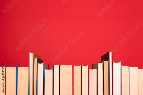 Row of book on a red background
