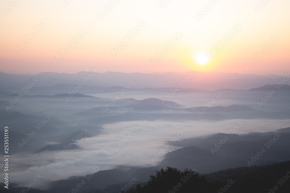 Layer of Mountain in morning sunrise and winter fog,