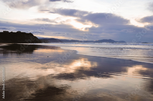  Beautiful sunset on the beach of sopelana with warm tones and an incredible sky. vizcaya  basque country  spain