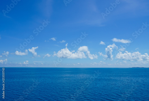 Cruising on the ocean on a beautiful cloudy blue sky day. © Joni