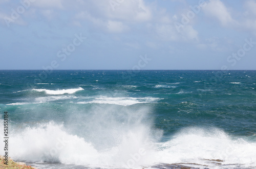 View of Beautiful Surging Ocean Waves Near a Shore. It`s Background of Blue Horizon Line. 
