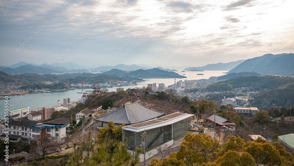 Panoramic, scenic view of Onomichi City and the Seto Inland Sea during sunset as seen from the Senkoji Park Observatory which is located on the summit of Mt. Senkoji in Hiroshima Prefecture in Japan.