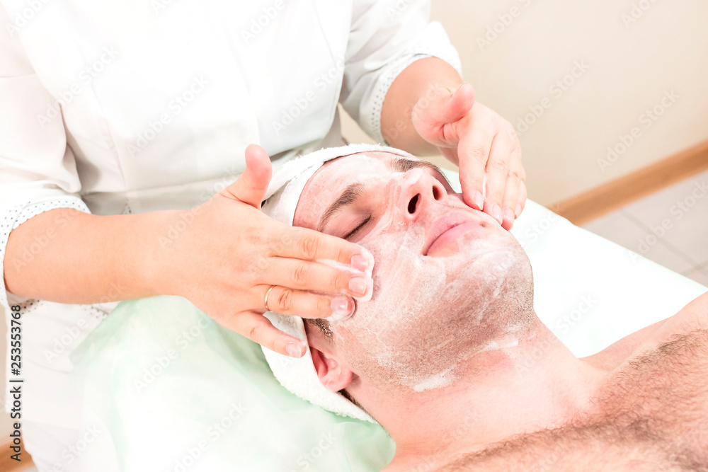Man in the mask cosmetic procedure in spa salon Man in the mask cosmetic procedure in spa salon