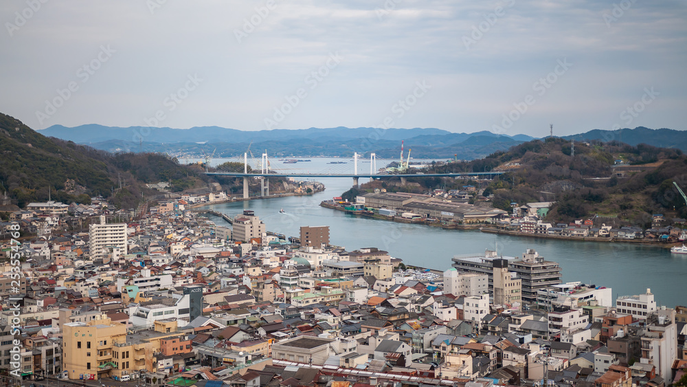Panoramic, scenic view of Onomichi City and the Seto Inland Sea as seen while climbing the countless steps towards the summit of Mt. Senkoji in Hiroshima Prefecture in Japan.