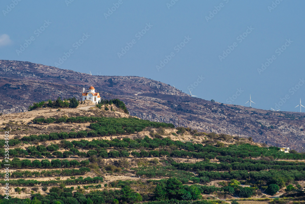 ?retan Landscape with lots of olive trees over the rolling hills, Crete, Greece and churches on top of the hills