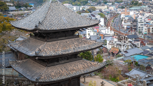 Landscape, scenic view of Onomichi City and the famous Tenneiji 3-story pagoda as seen while climbing the countless steps towards the summit of Mt. Senkoji in Hiroshima Prefecture in Japan. photo