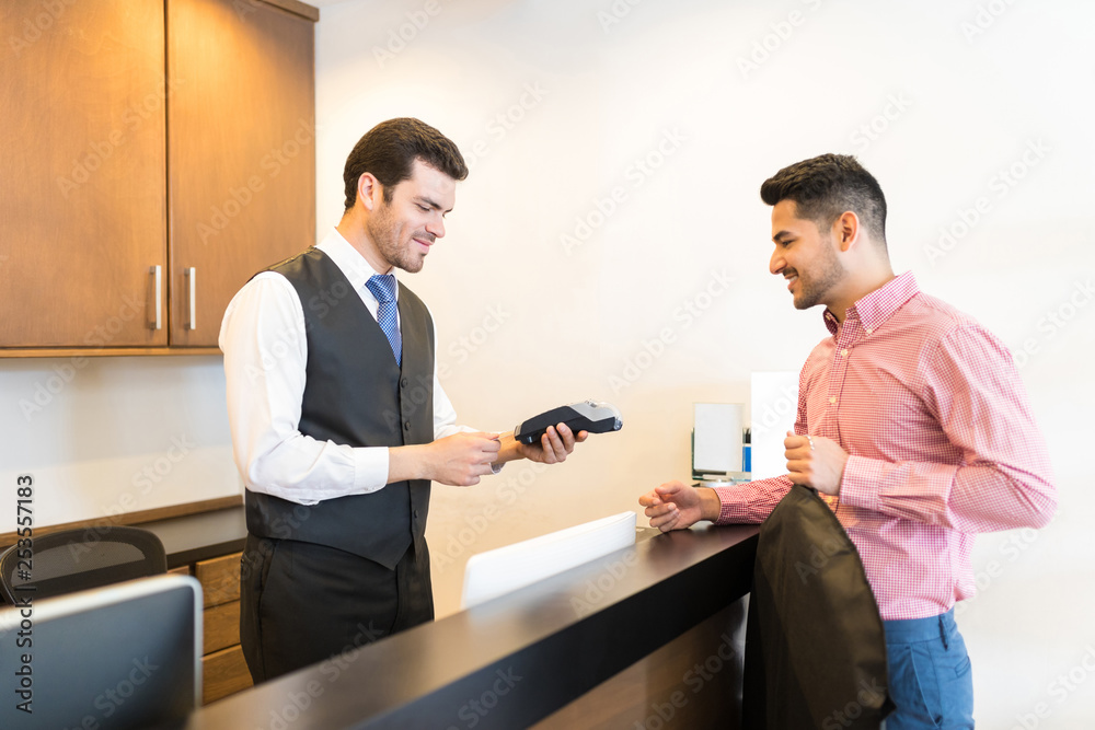 Client Paying Through Credit Card At Rental Store Client Paying Through Credit Card At Rental Store