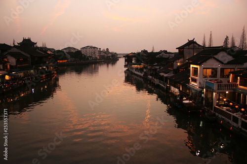 Beautiful sunset in Zhujiajiao ancient town, China. Traditional chinese arhitecture, ships on water, river