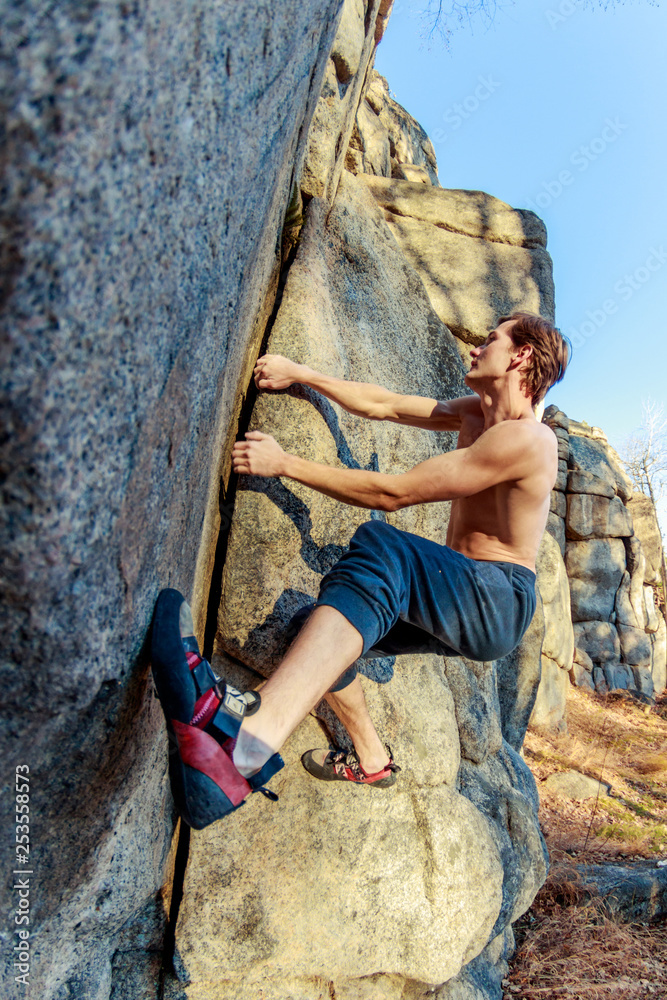 rrock shoe close-up of a rock climber climbs a boulder over a rock without insurance