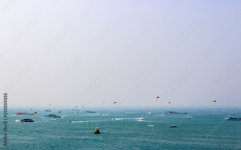 View of the air pollution and smoke in the sky at Pattaya city, Thailand. Boat in the blue sea. 