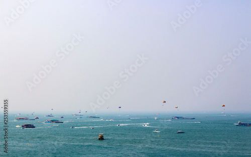 View of the air pollution and smoke in the sky at Pattaya city, Thailand. Boat in the blue sea. 