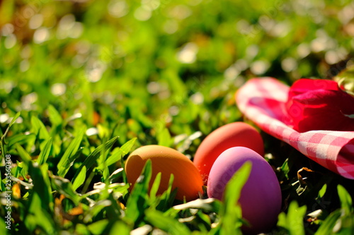 Happy easter eggs on grass of sunset