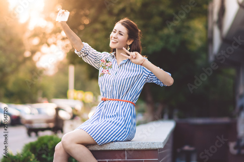 brunette girl makes selfie on the street 