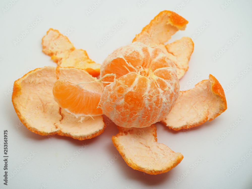 Mandarin is cleared from the skin. Fruit on white background. Mandarin is cleared from the skin. Fruit on white background.