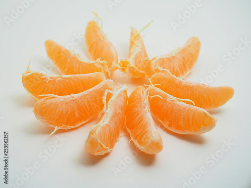 Mandarin is cleared from the skin. Fruit on white background.