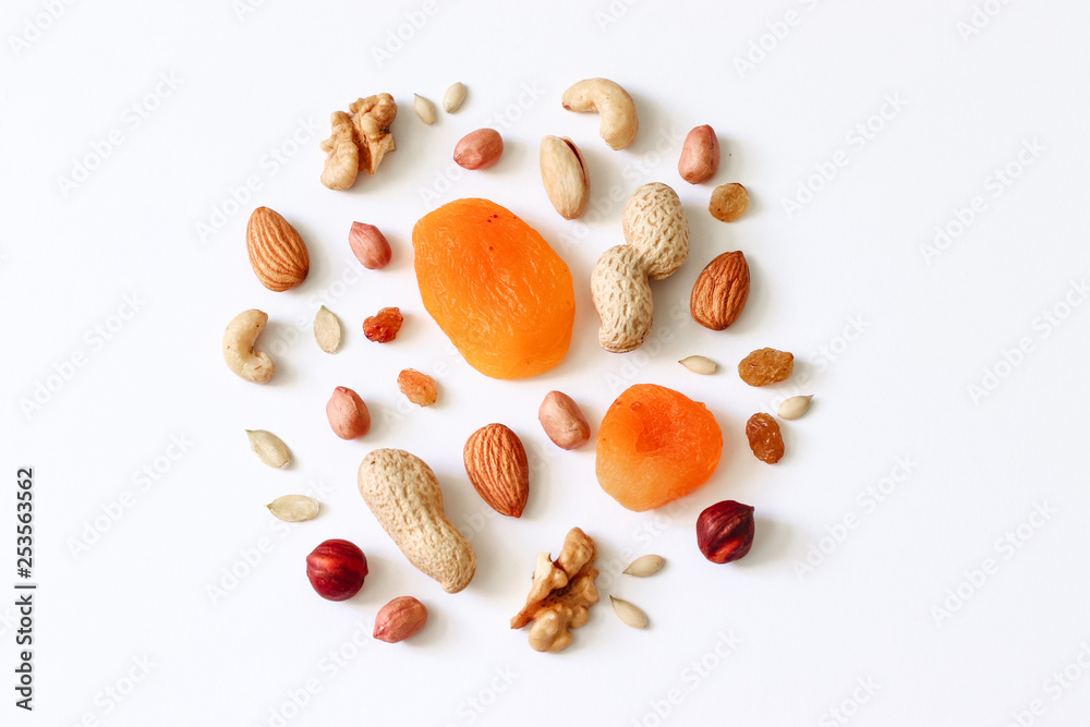 Assorted nuts on a white table. Hazelnuts, cashews, peanuts, walnuts, almonds.