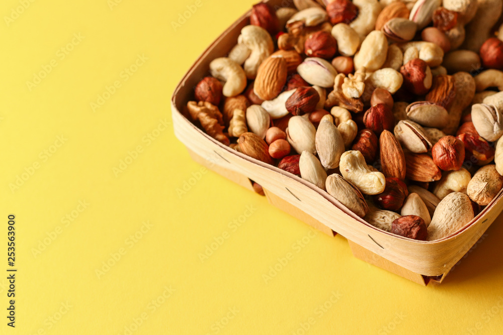 Dried fruits and nuts mix in a wooden bowl. 