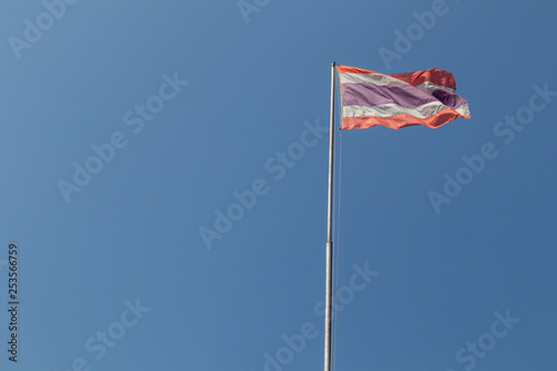 Thailand flag on clear blue sky background.
