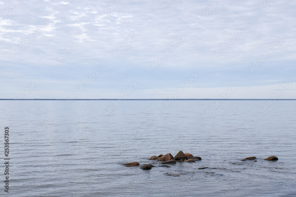 Seascape with stones in a calm water Seascape with stones in a calm water